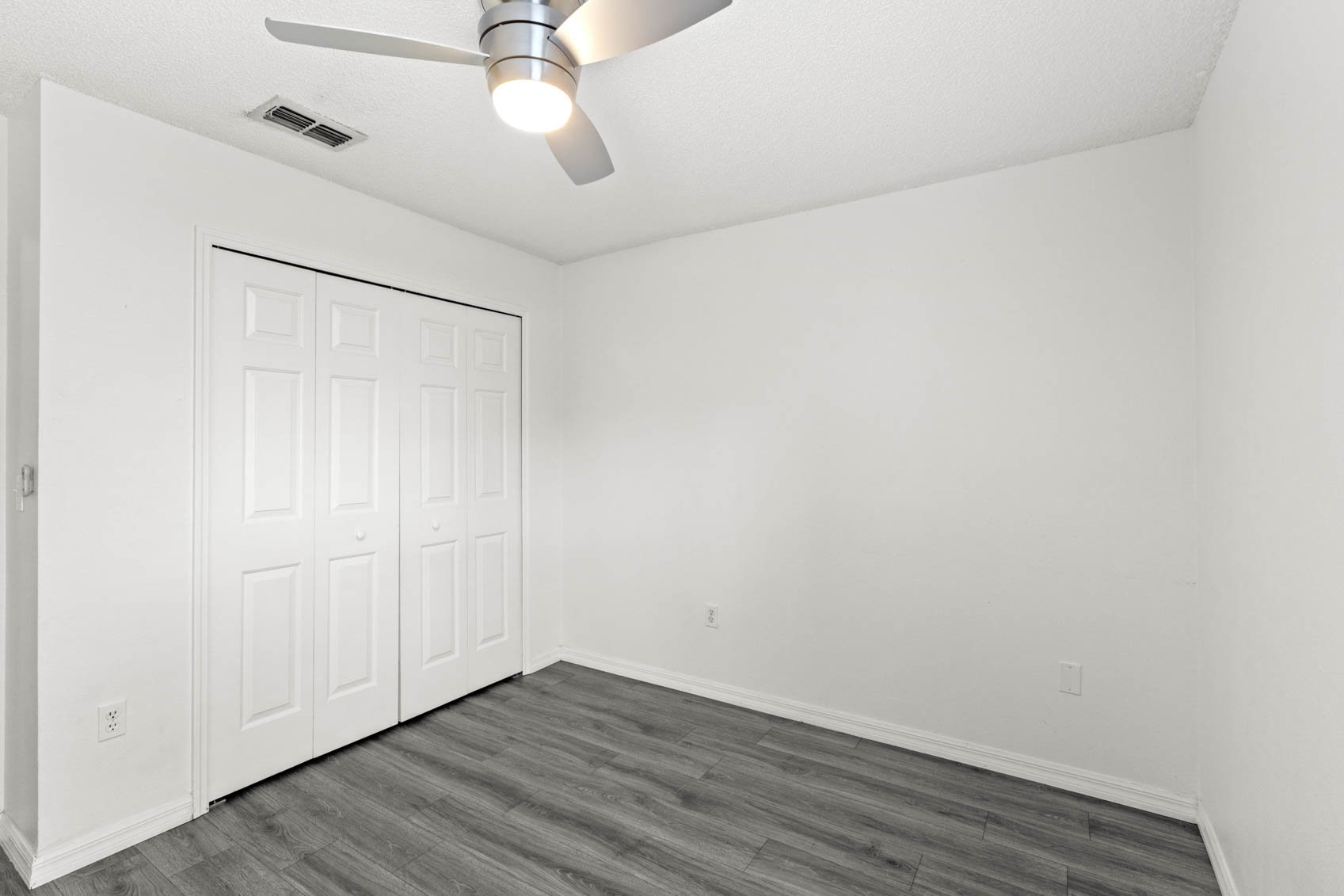 bedroom with grey wooden floors
